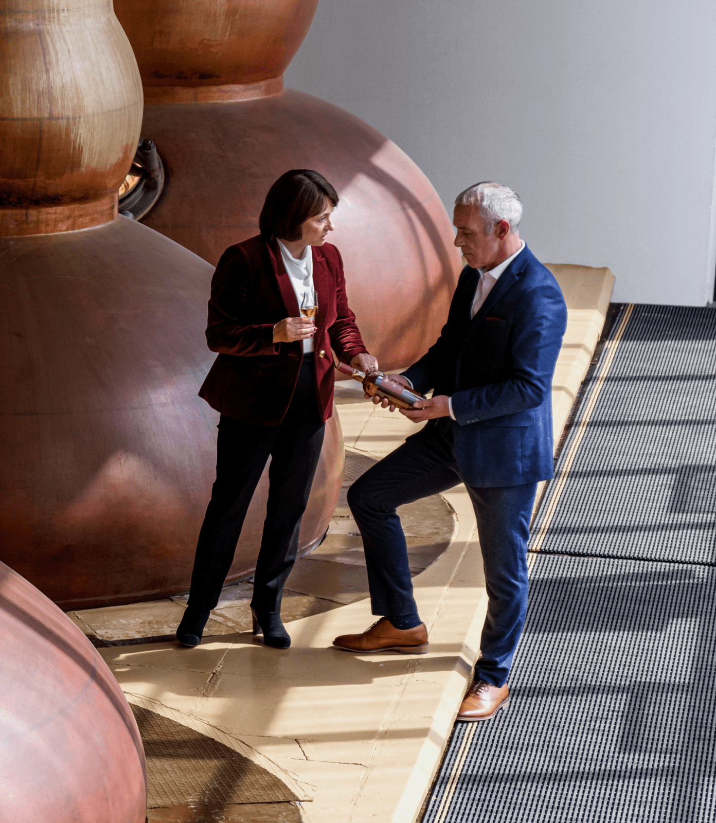 Expert craftspeople inspecting a bottle of The Glendronach 12 Years