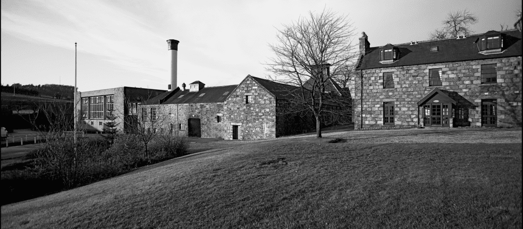 A current black and white photo of The Glendronach Distillery stone buildings.